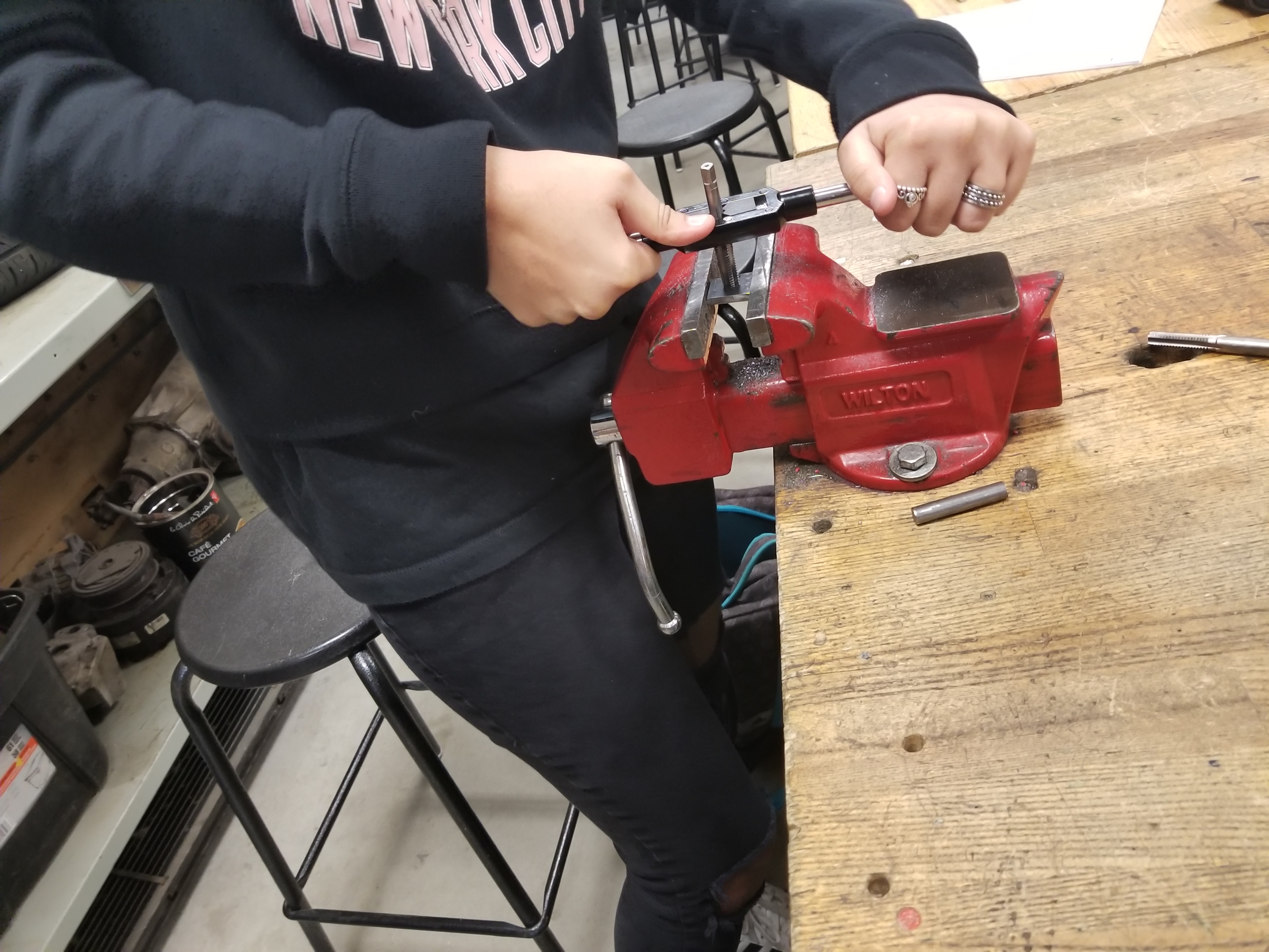 Creating Nut and Bolt For this part, we had to cut pieces of steel to make a nut and bolt. We then used a tap to create a hol