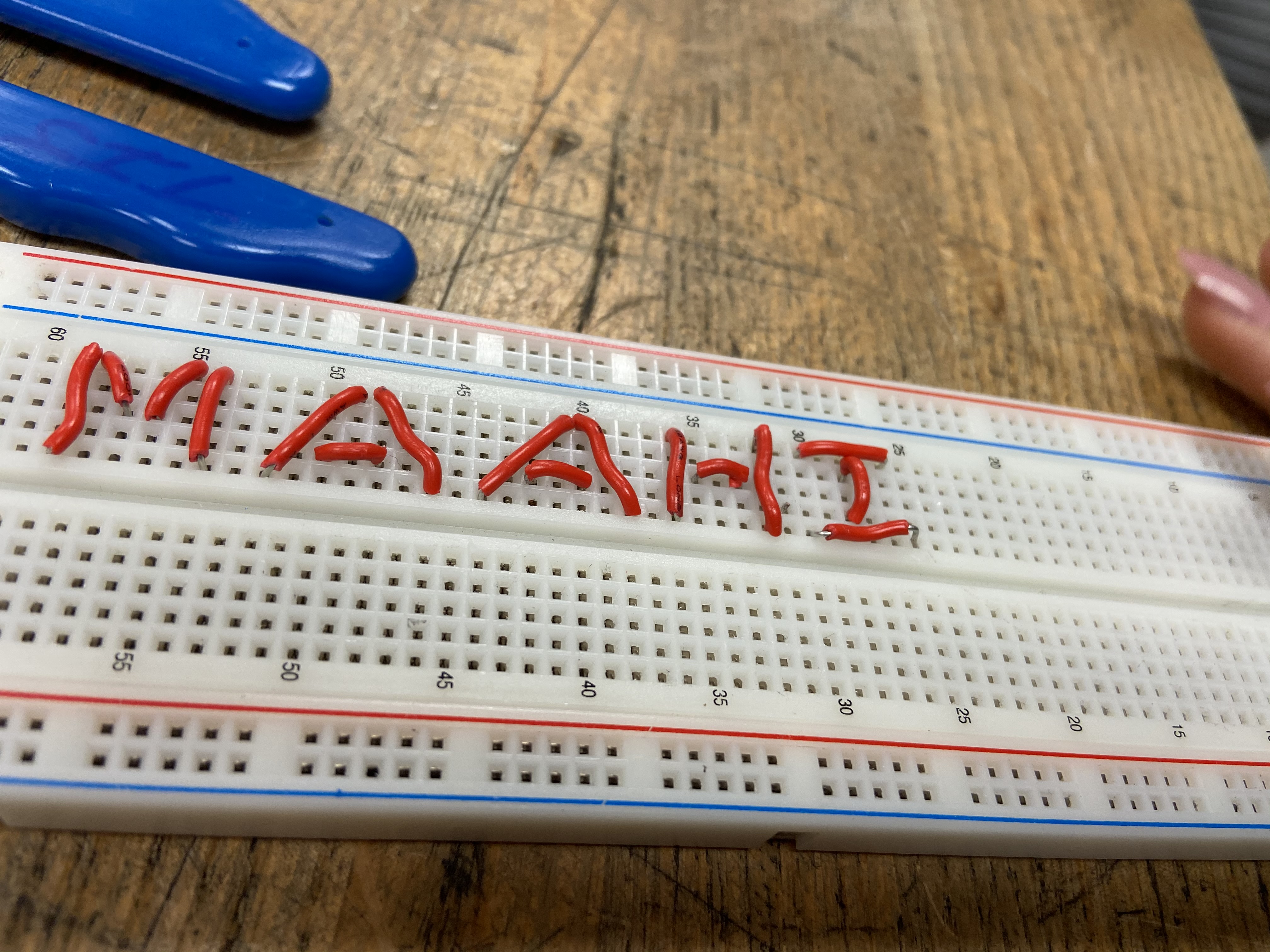 Creating your name on a breadboard, for this task, we used wires to spell out our name on a breadboard.
