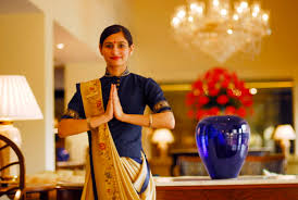 Should put hands in the praying position and say Namaste. This means "I bow to you". It is a great sign of respect and should