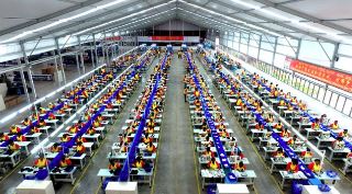 Numerous factory workers in China working hard to produce goods.