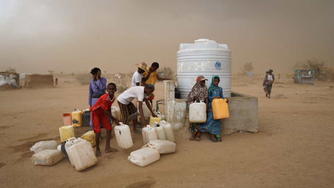 Picture of people in yemen using what little of clean water they have