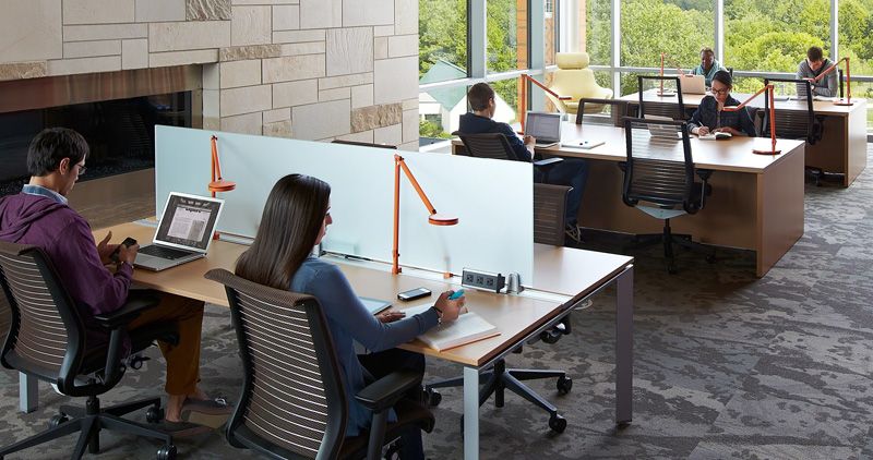 Places to sit and work: computers for people to use. Desks for people to sit down and work with outlets near by to charge lap